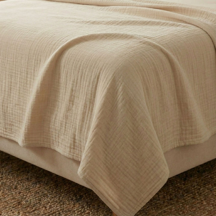 Close-up view of the Milos top sheet highlighting its muslin cotton texture and soft natural finish.