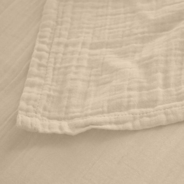 Detail of the Milos top sheet edge showing its lightweight weave and breathable fabric.