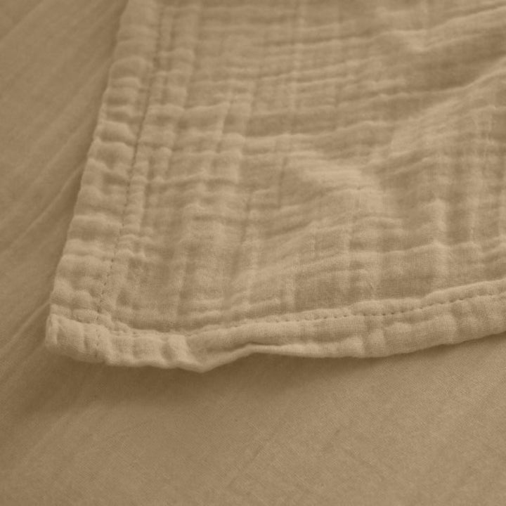 Detail of the Milos top sheet edge showing its lightweight weave and breathable fabric.