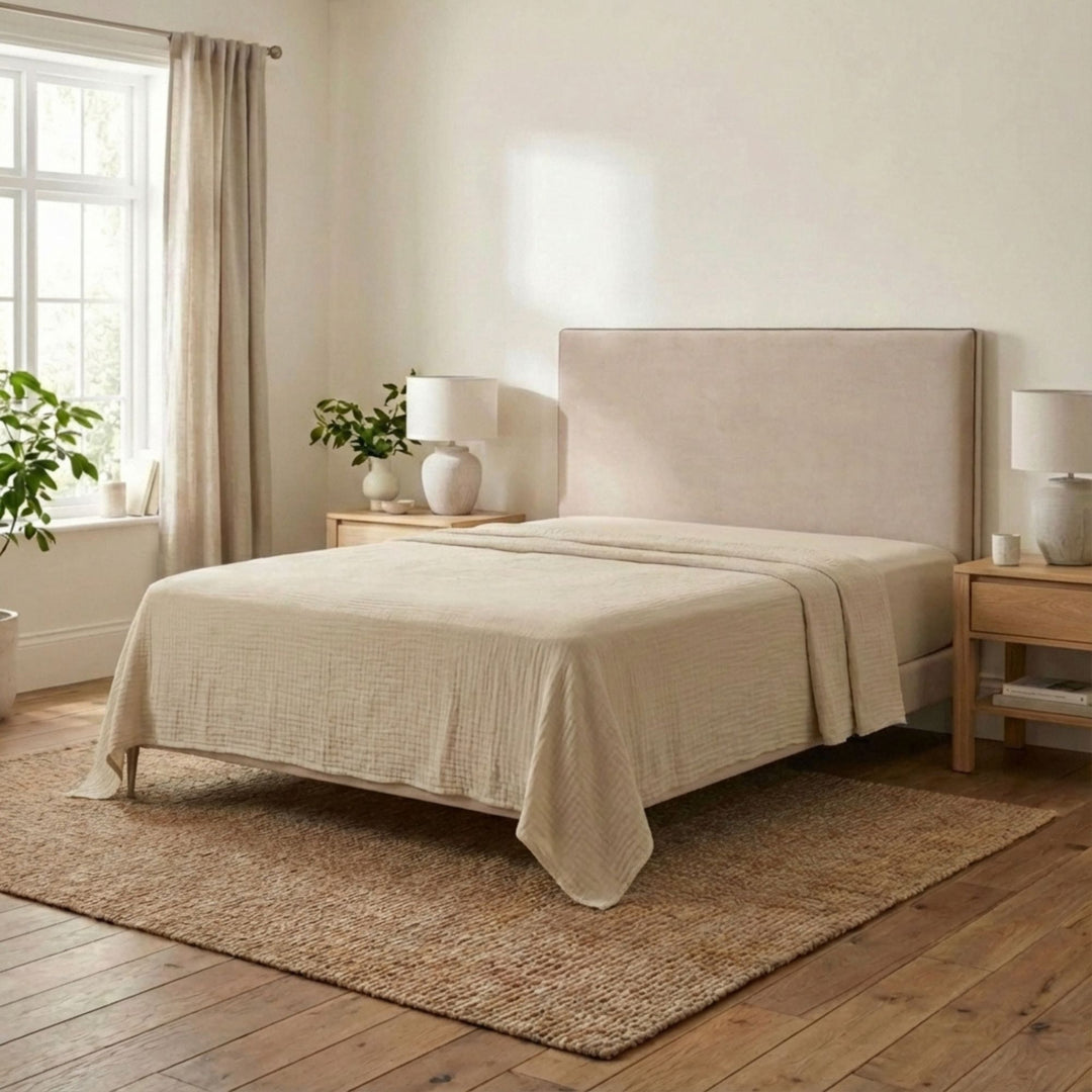 Bedroom setting featuring the Milos top sheet draped loosely over a bed for a relaxed look.