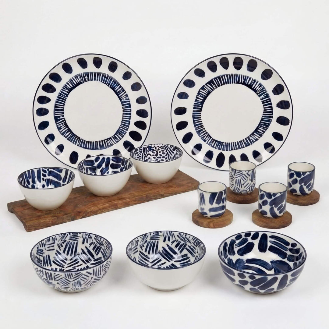Complete Milos tableware collection featuring ceramic plates, bowls, and cups with blue patterns.