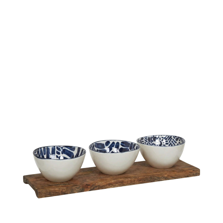 Side view of aperitif ceramic bowls displaying different hand-painted blue designs.