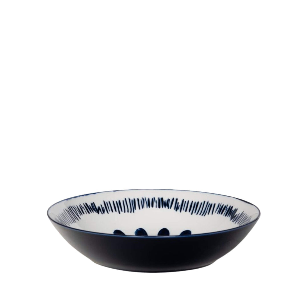 Side view of a Milos soup bowl showcasing circular blue decorative motifs.