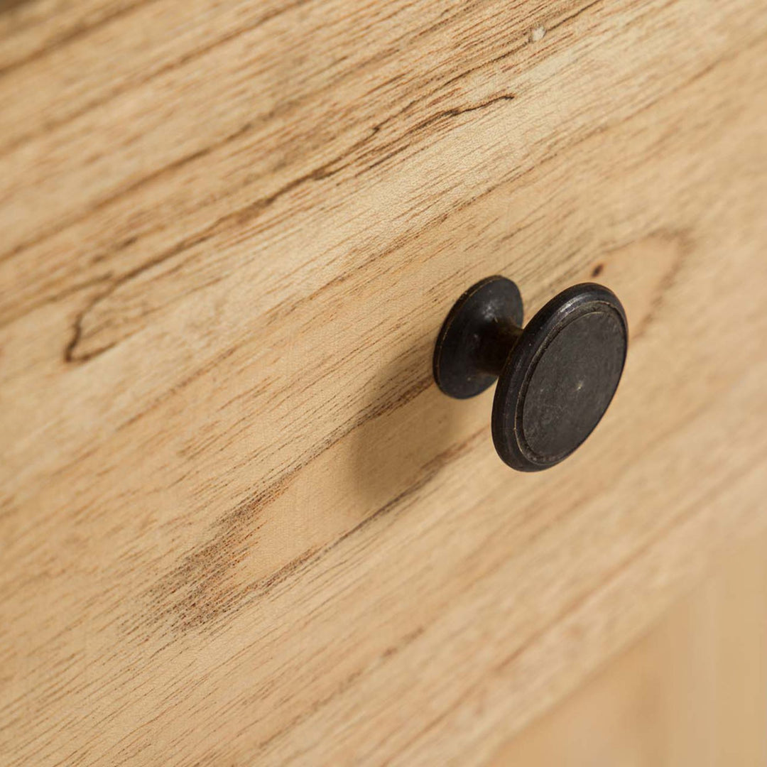 Close-up of the round knob showing the contrast between the dark handle and natural wood finish.