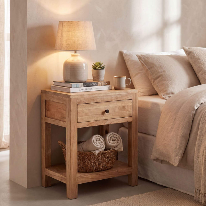 Styled bedroom setting featuring the mindi bedside table beside a bed in a warm natural interior.