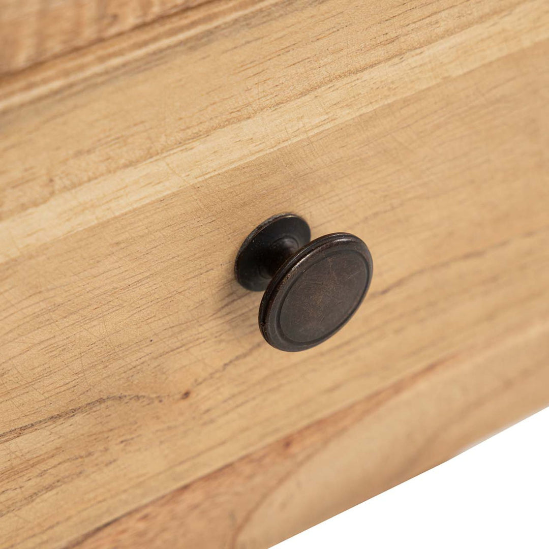 Close-up detail of the drawer knob and wood surface showing the natural grain texture.