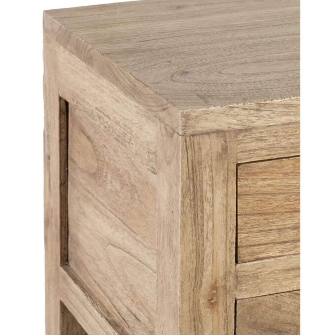 Close-up of the drawer fronts and round knobs showing the natural mindi wood grain.