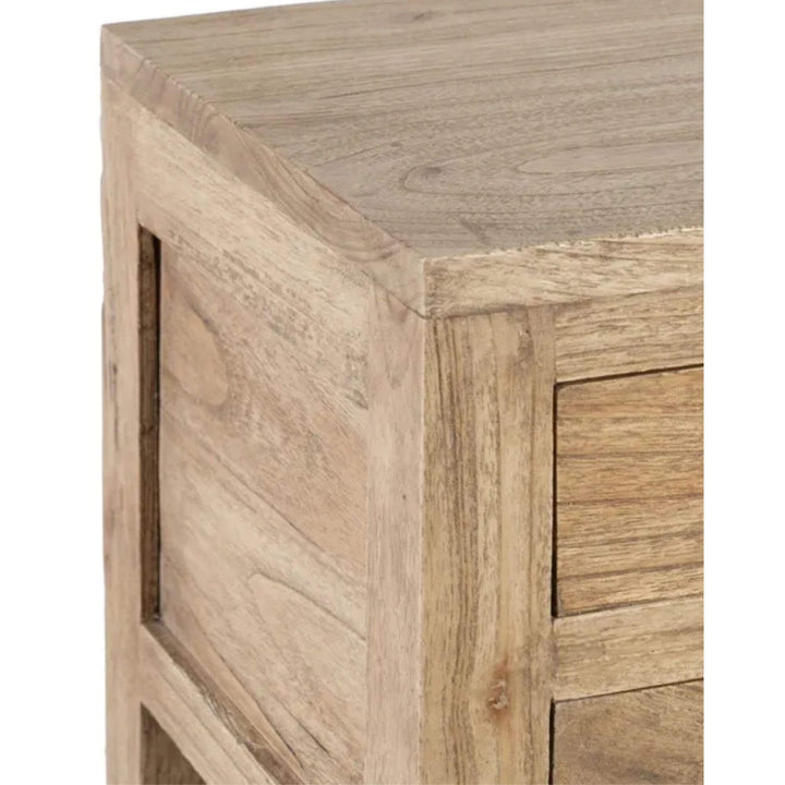 Close-up of the drawer fronts and round knobs showing the natural mindi wood grain.