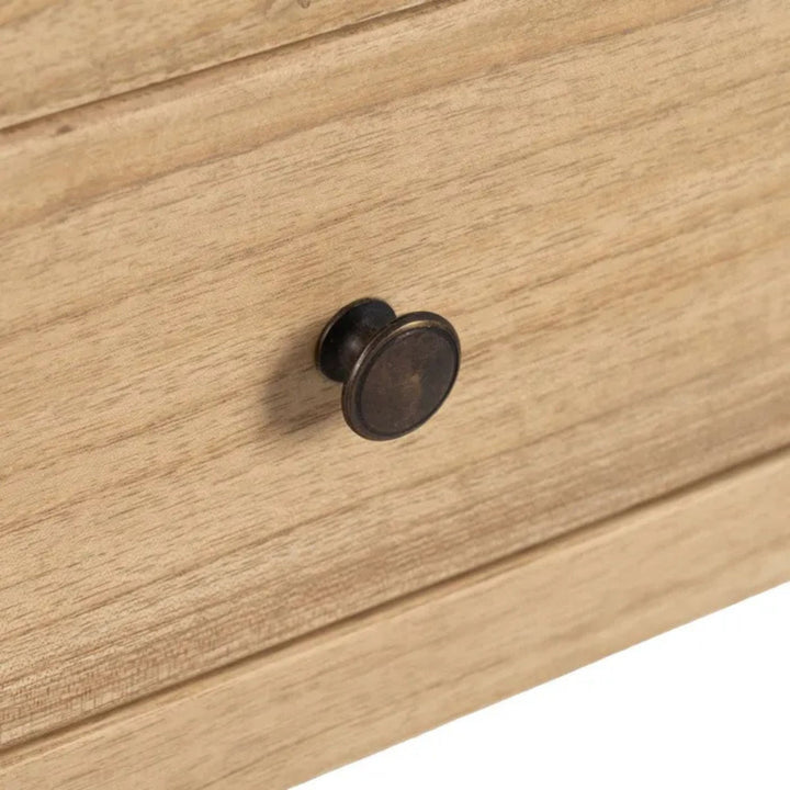 Close-up of the drawer front and round knob showing the natural wood texture.