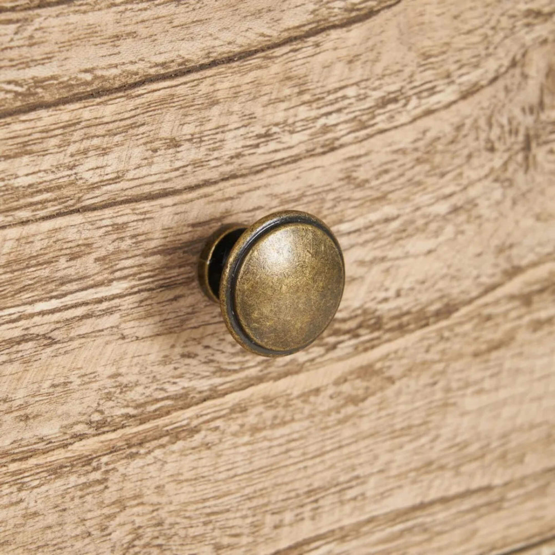 Close-up detail of the drawer front and round knob showing the natural wood texture.