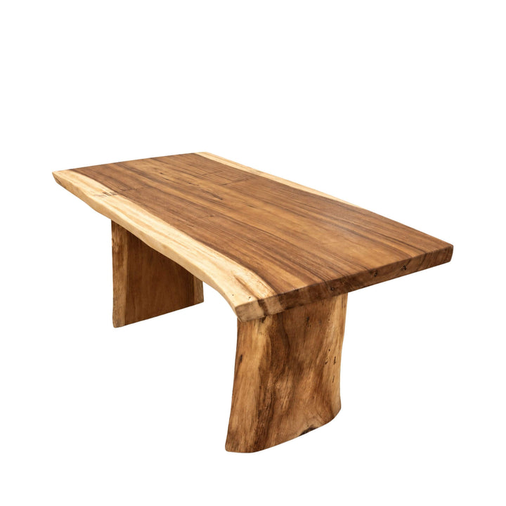 Angled view of the Minerva dining table showing its rectangular suar wood top and sculptural panel-style legs