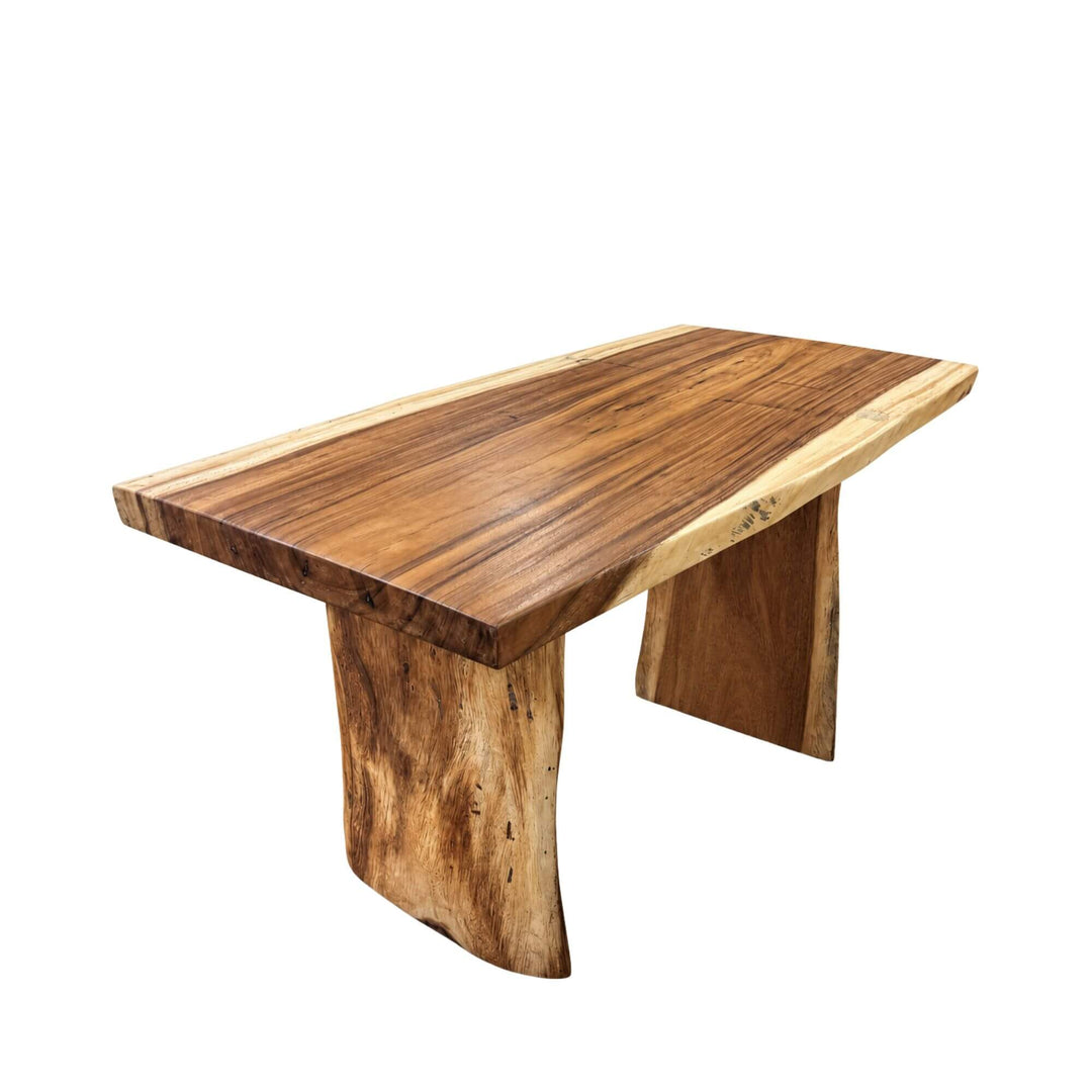 Front angled view of the Minerva suar wood dining table with expressive natural grain and sculptural wooden legs