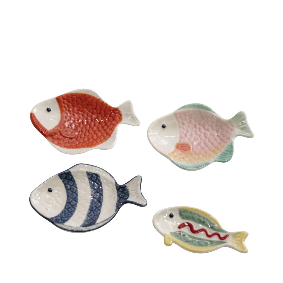 Set of mini ceramic fish dishes in assorted glazed colors and patterns.