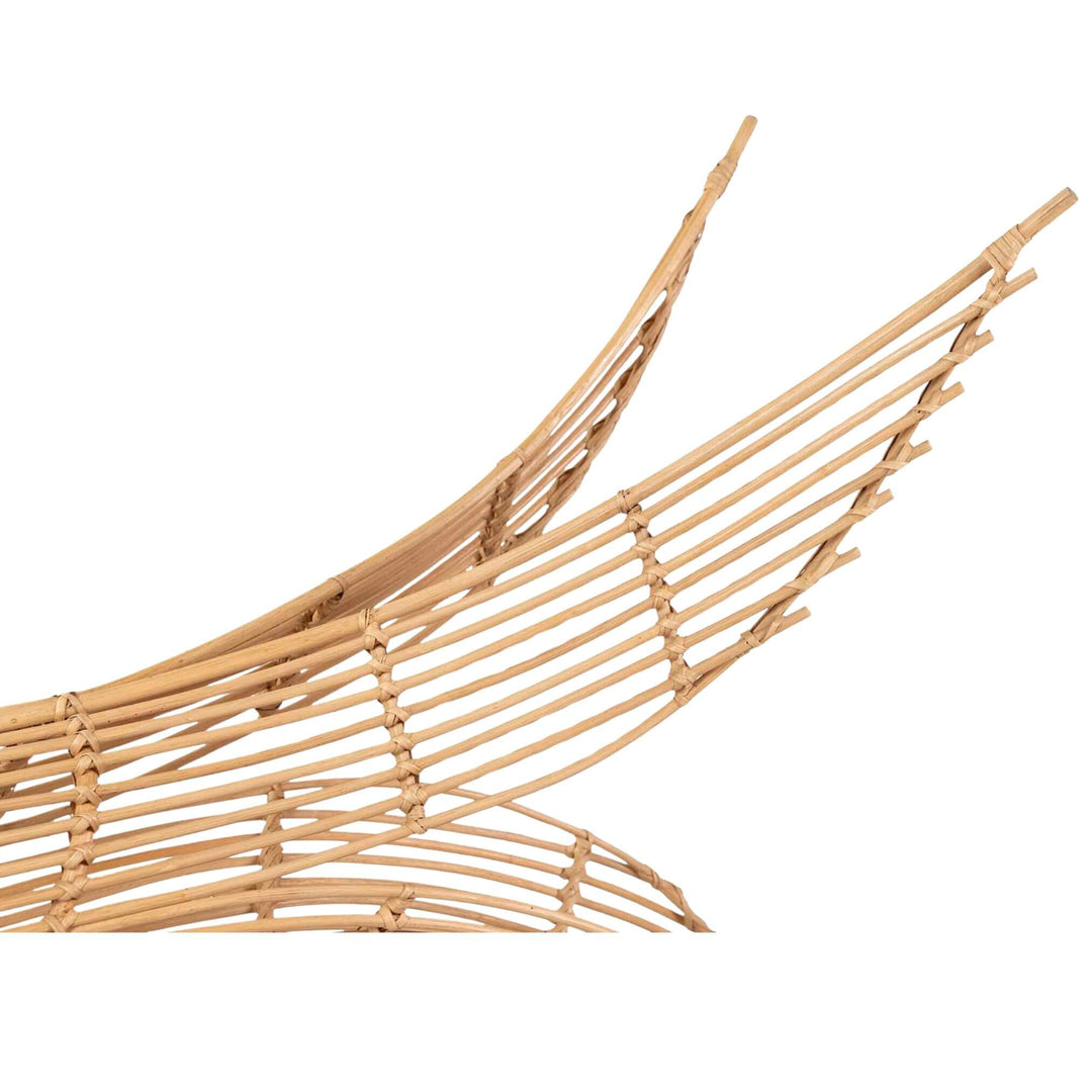 Close-up of Artistic rattan whale-shaped pendant lamp for bohemian and coastal interiors.
