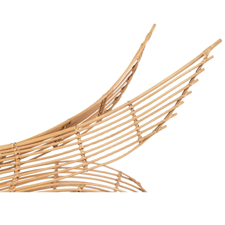 Close-up of Artistic rattan whale-shaped pendant lamp for bohemian and coastal interiors.