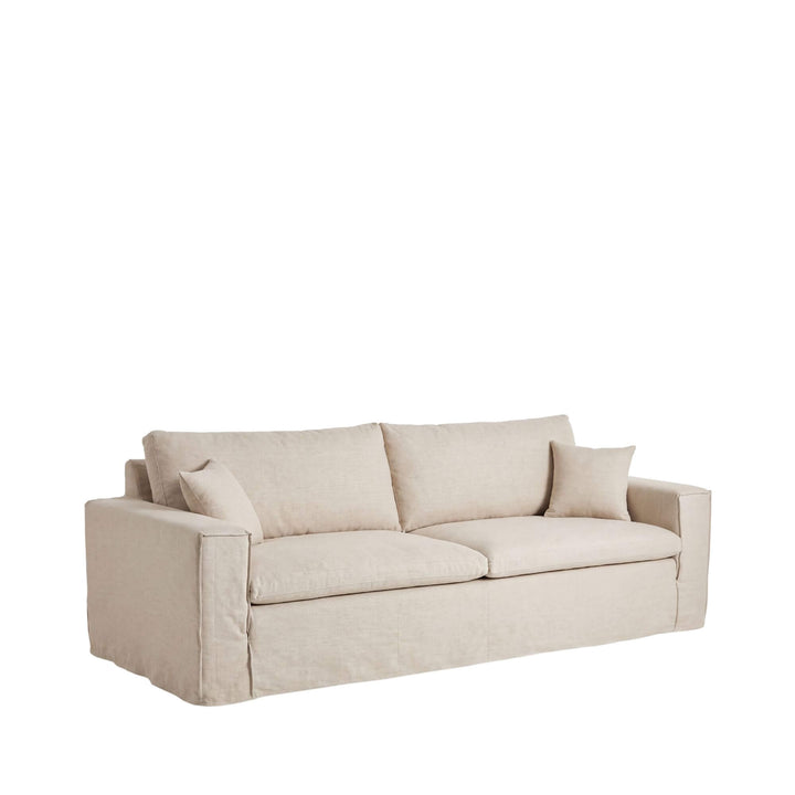 Front angled view of the Modena sofa upholstered in soft natural beige linen with generous seat and back cushions