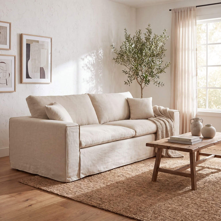 Modena linen sofa styled in a bright Mediterranean-inspired living room with warm natural textures