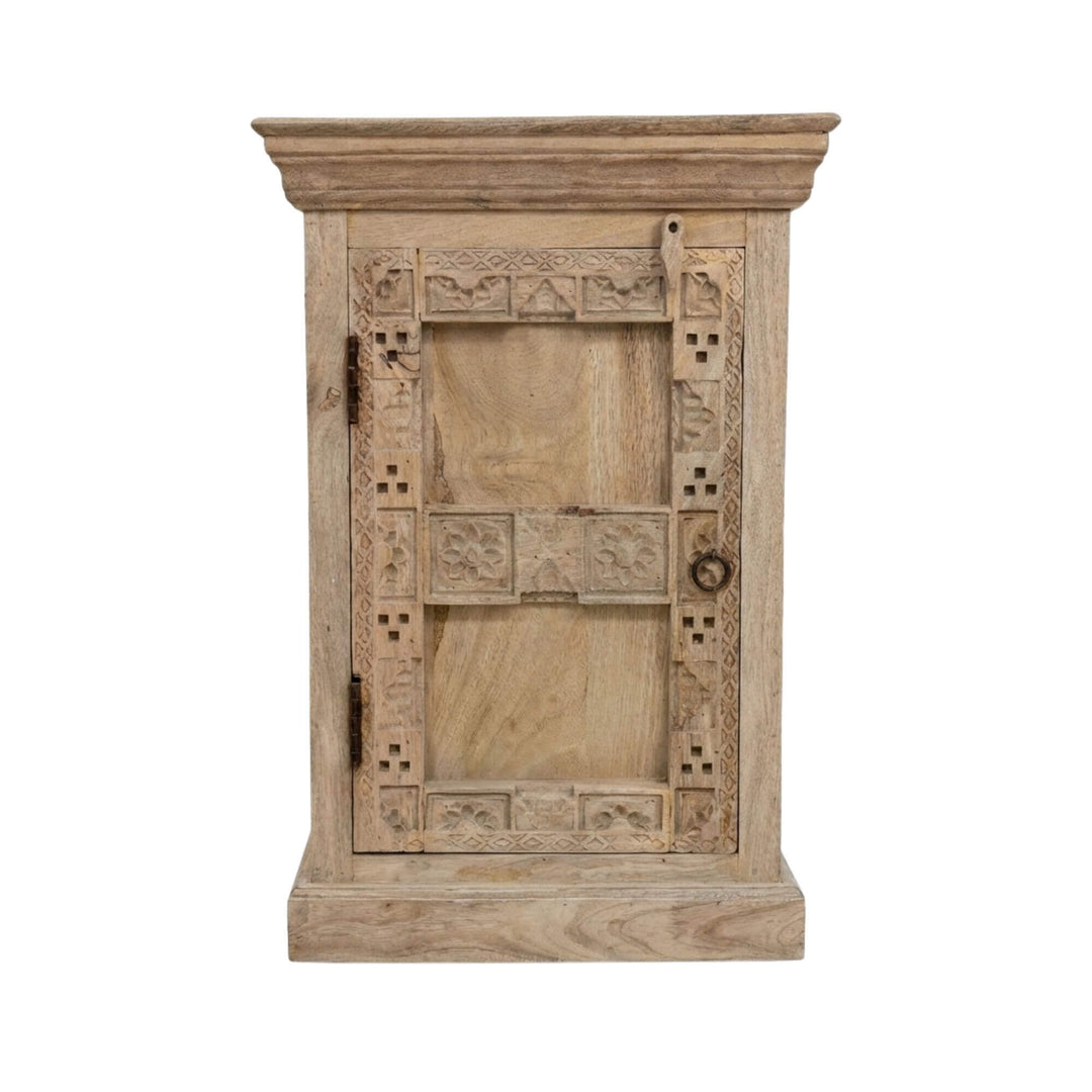 Front view of the Moheli bedside table made from reclaimed wood with carved door details.