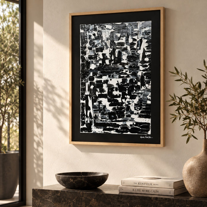 Monochrome painting by Manuel Pereyra displayed above a console in a warm contemporary interior