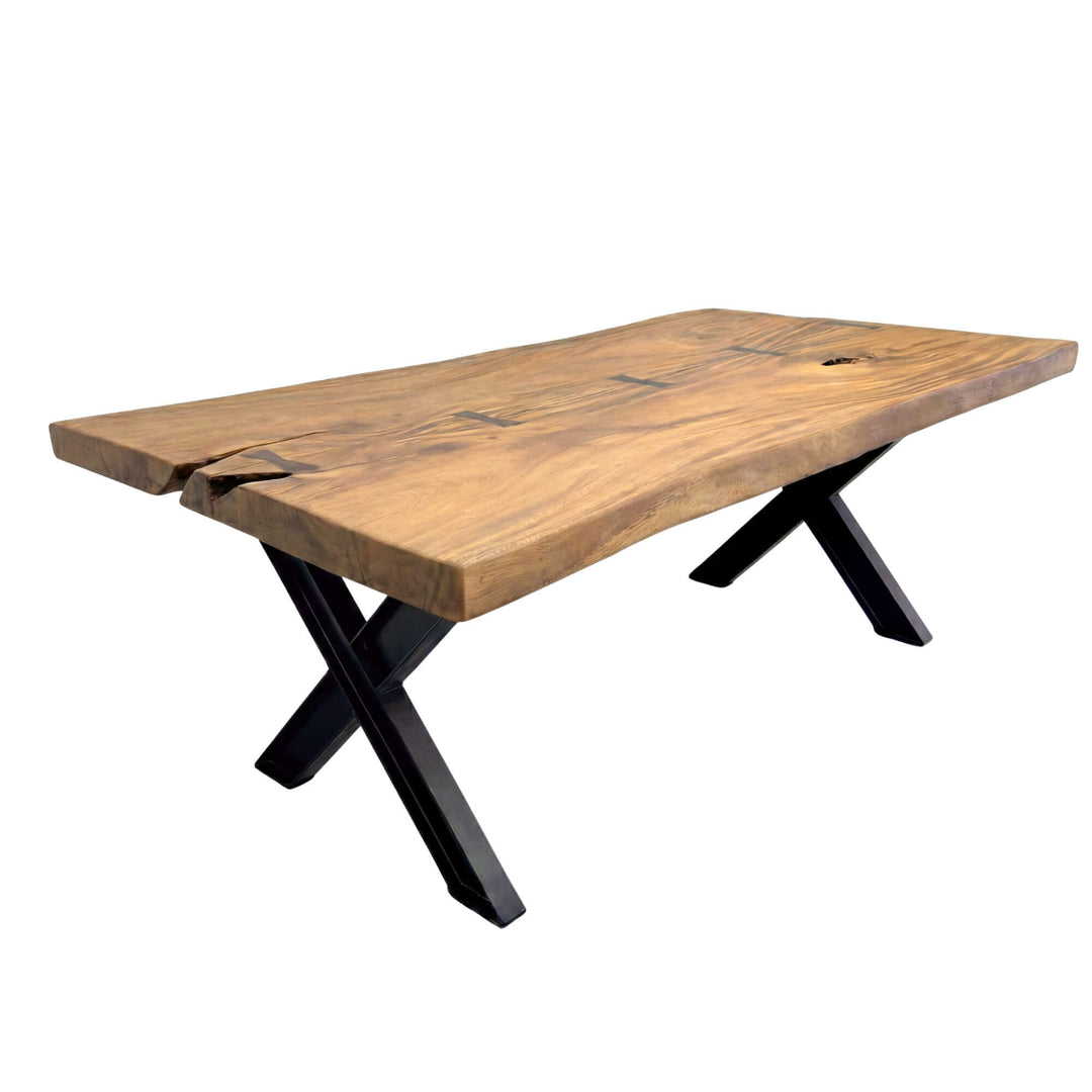 Front view of the Moorea X suar wood dining table showing its solid wood top and black X-shaped base.
