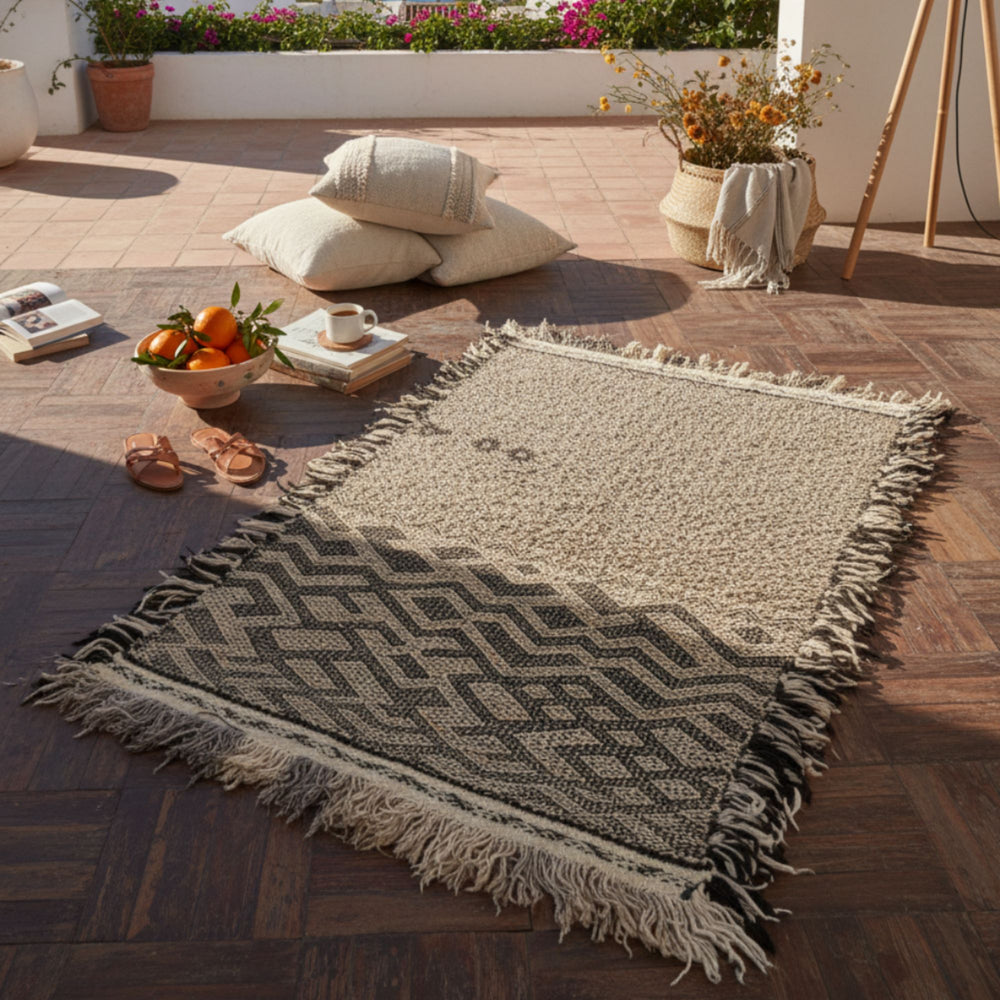 Outdoor terrace scene featuring the Moroccan rug styled with cushions.