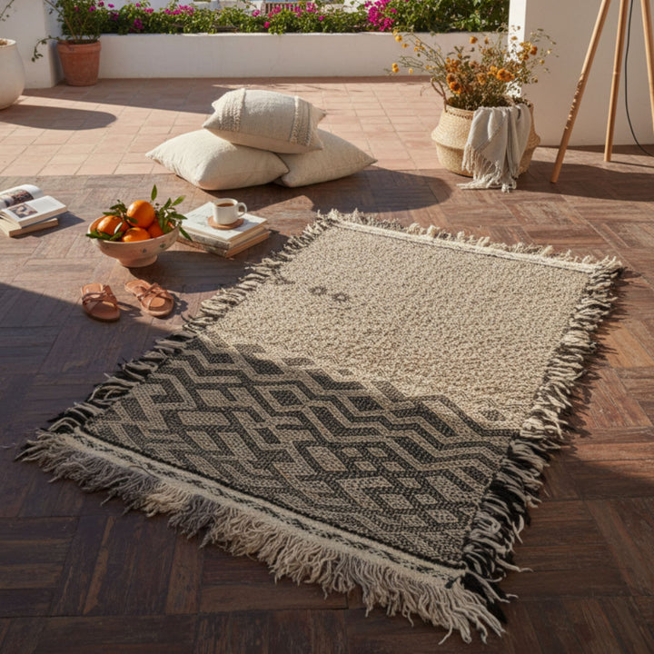 Outdoor terrace scene featuring the Moroccan rug styled with cushions.