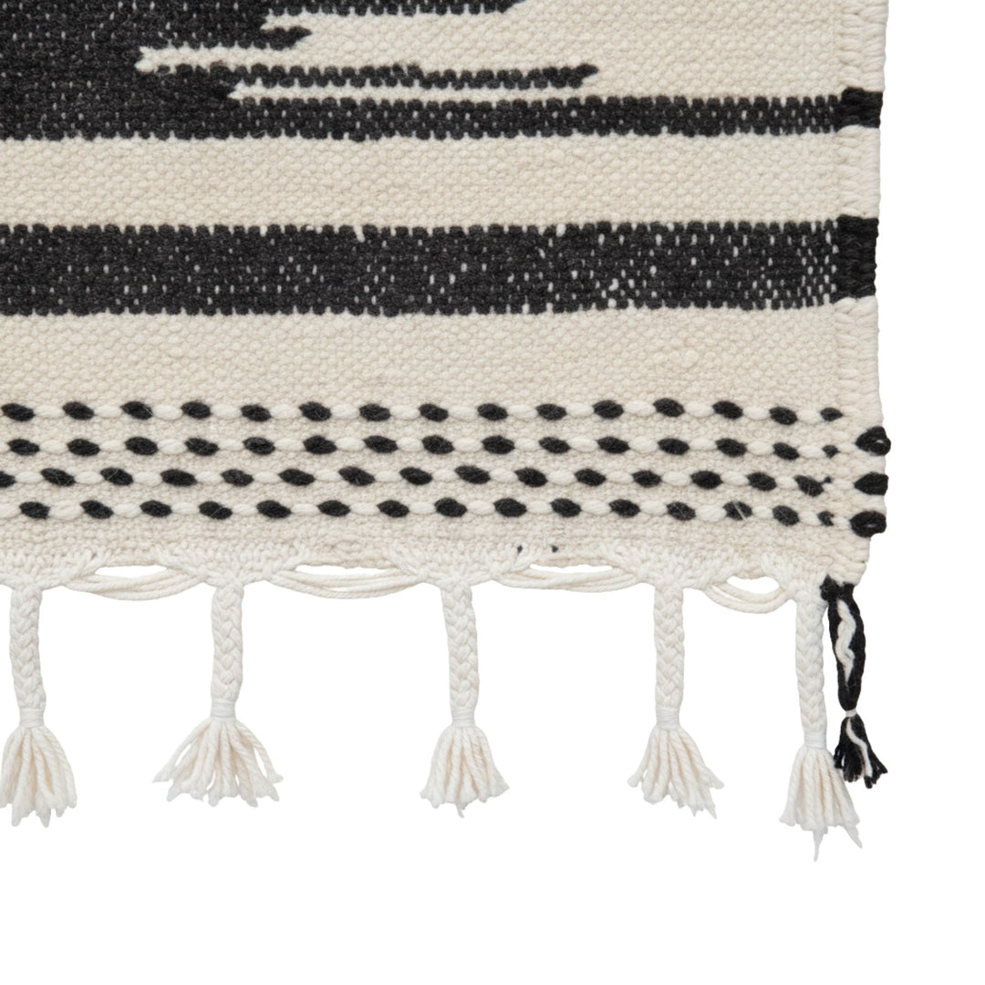 Close-up of the woven pattern and tassel detailing.