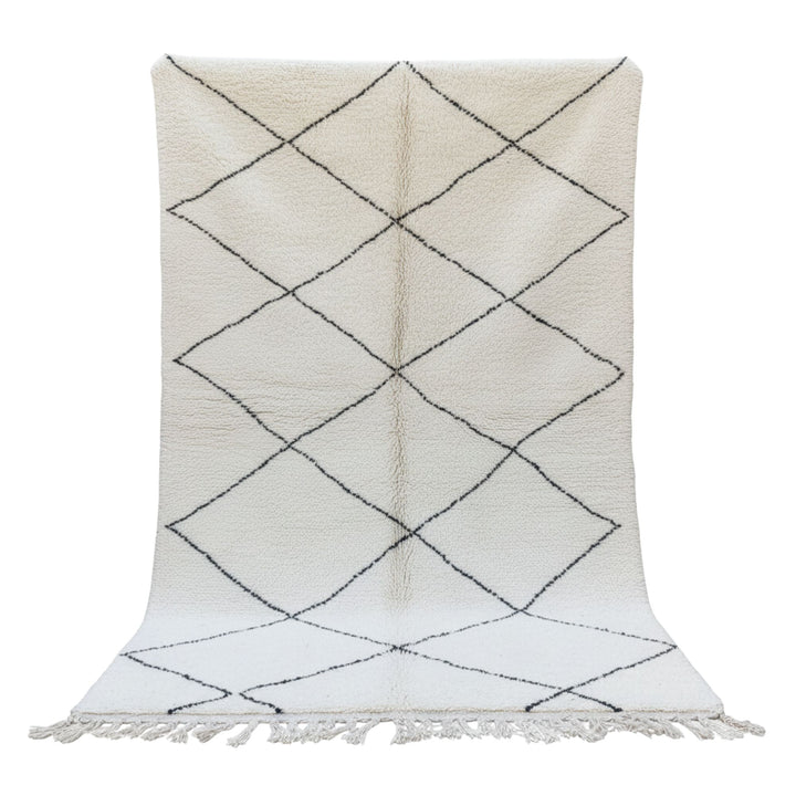 Front view of the Moroccan wool rug with cream background and black diamond pattern.