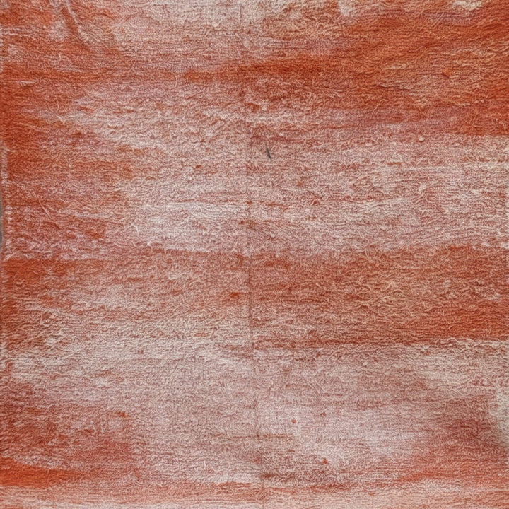 Close-up of the wool texture showing the terracotta and cream color blend.