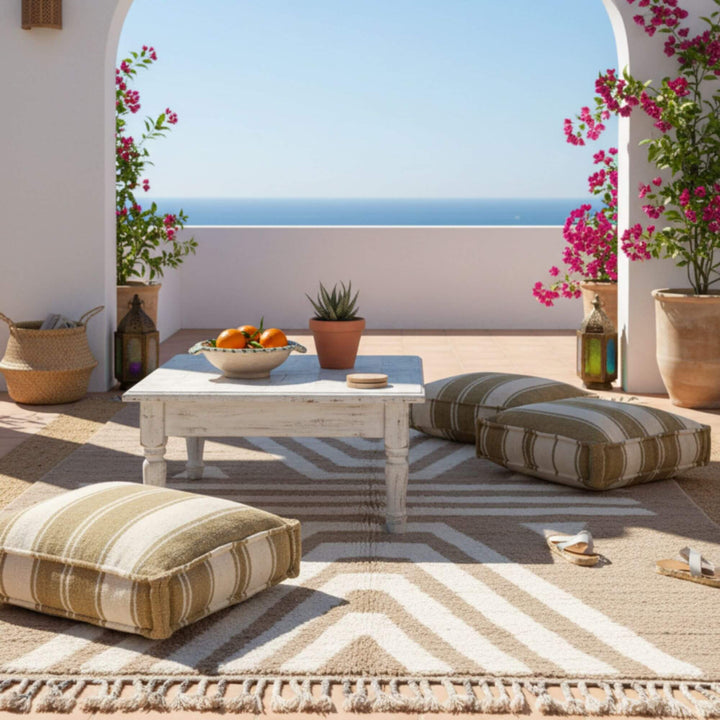 Outdoor terrace scene showcasing the Moroccan Rug in a bright seating area.