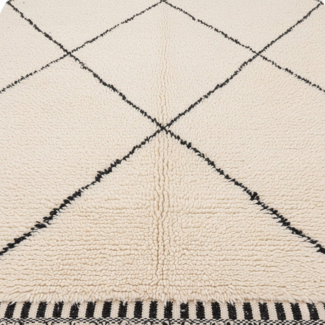 Close-up of the wool texture and diamond pattern on the Moroccan Rug.