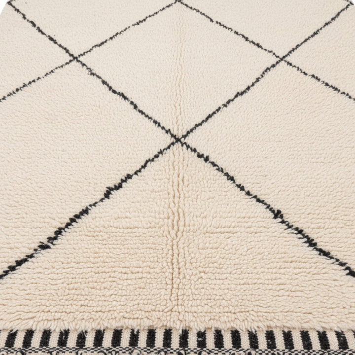 Close-up of the wool texture and diamond pattern on the Moroccan Rug.