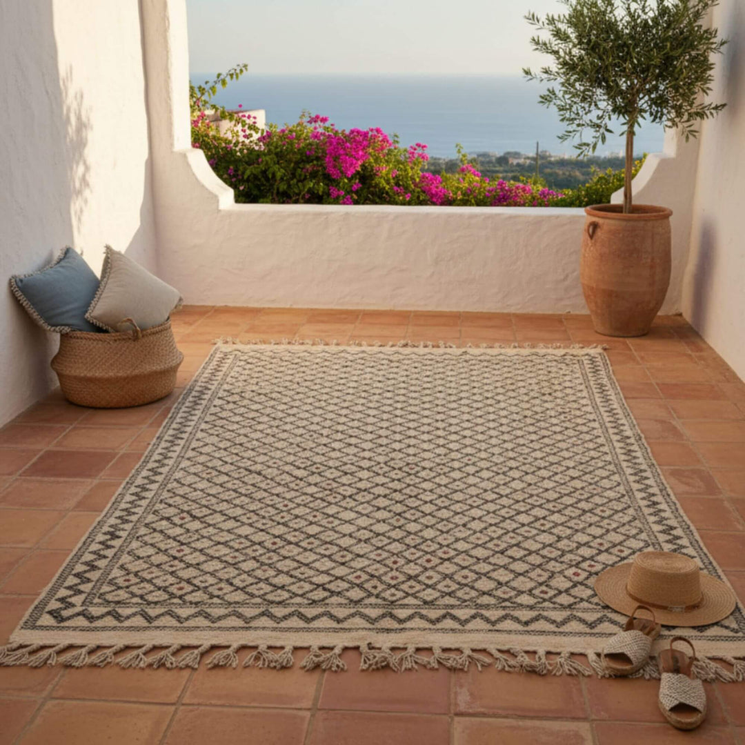 Outdoor terrace setting featuring the Moroccan Rug in natural light.