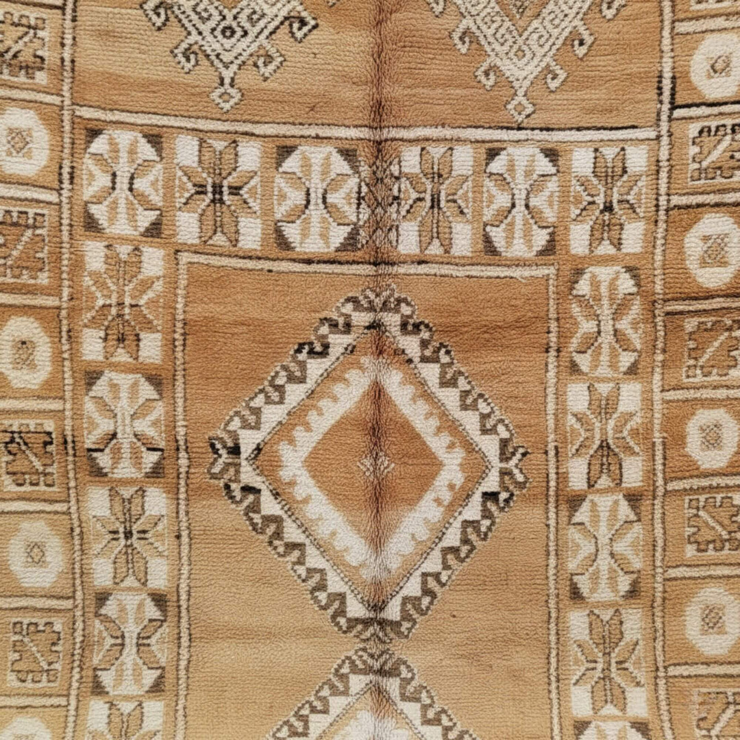 Close-up of the handcrafted geometric motifs in beige and sand hues.