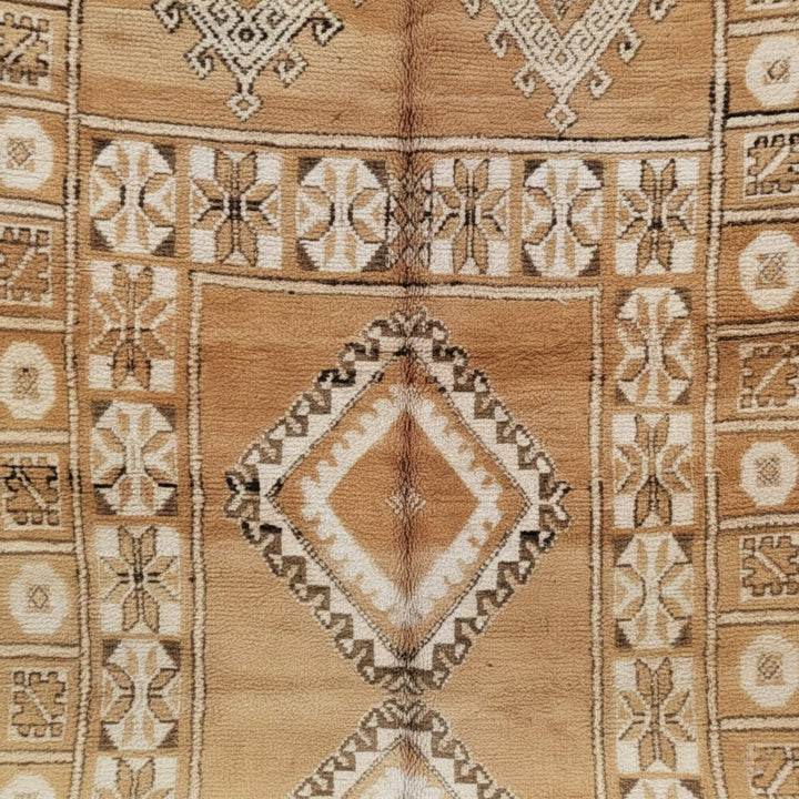 Close-up of the handcrafted geometric motifs in beige and sand hues.