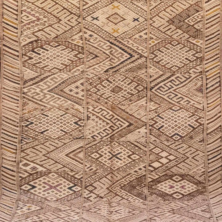 Close-up of the traditional Moroccan woven motif in natural wool tones.