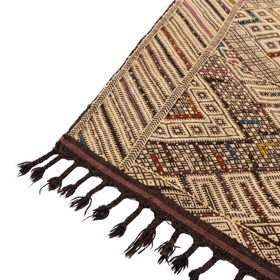 Close-up of the woven wool texture and ethnic pattern detail.