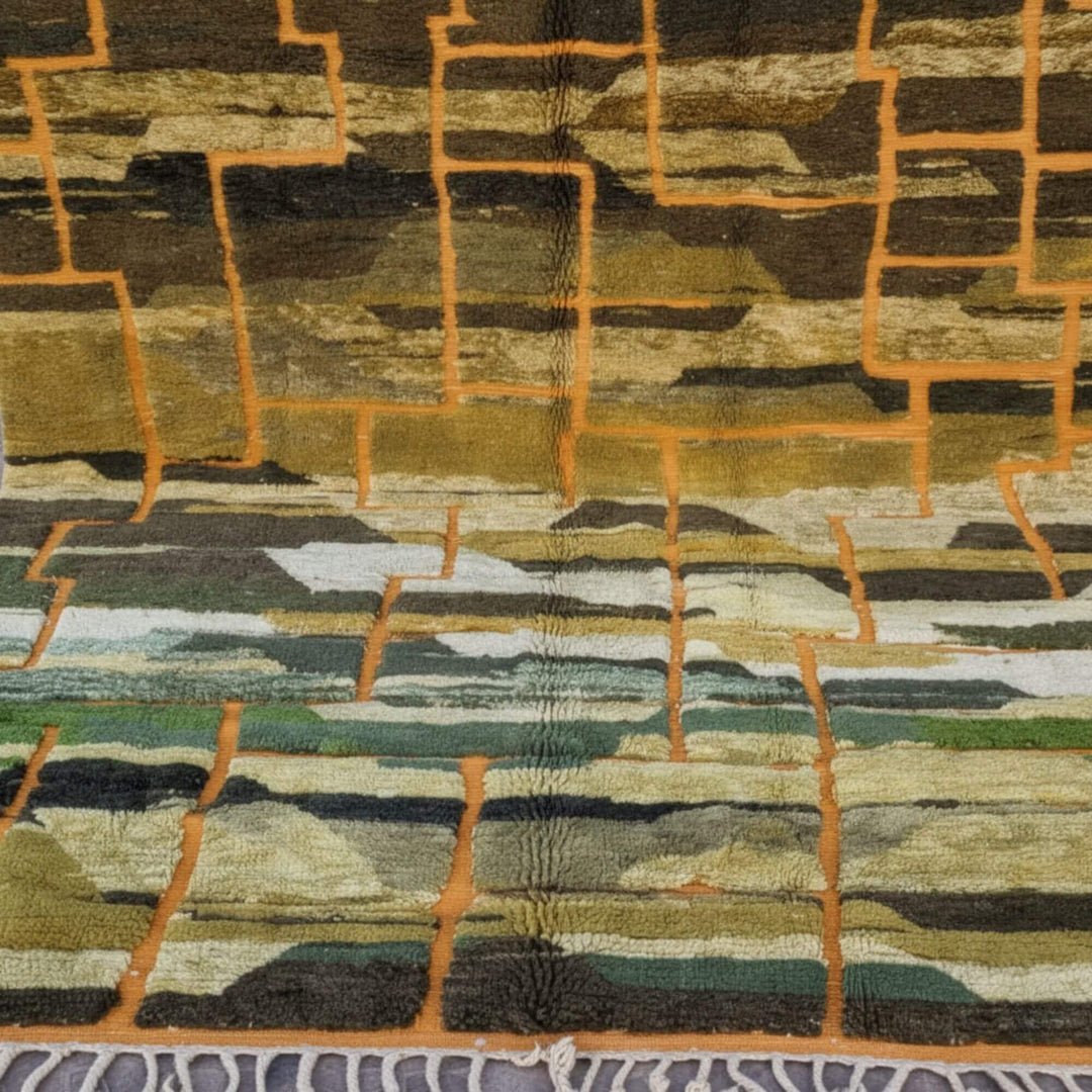 Close-up of the artistic geometric blocks in warm gold, green and earthy tones.