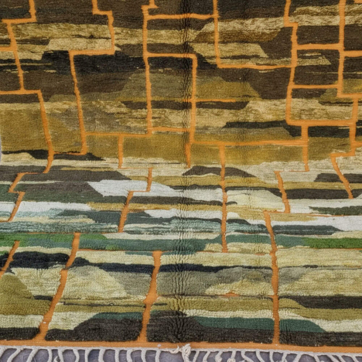 Close-up of the artistic geometric blocks in warm gold, green and earthy tones.