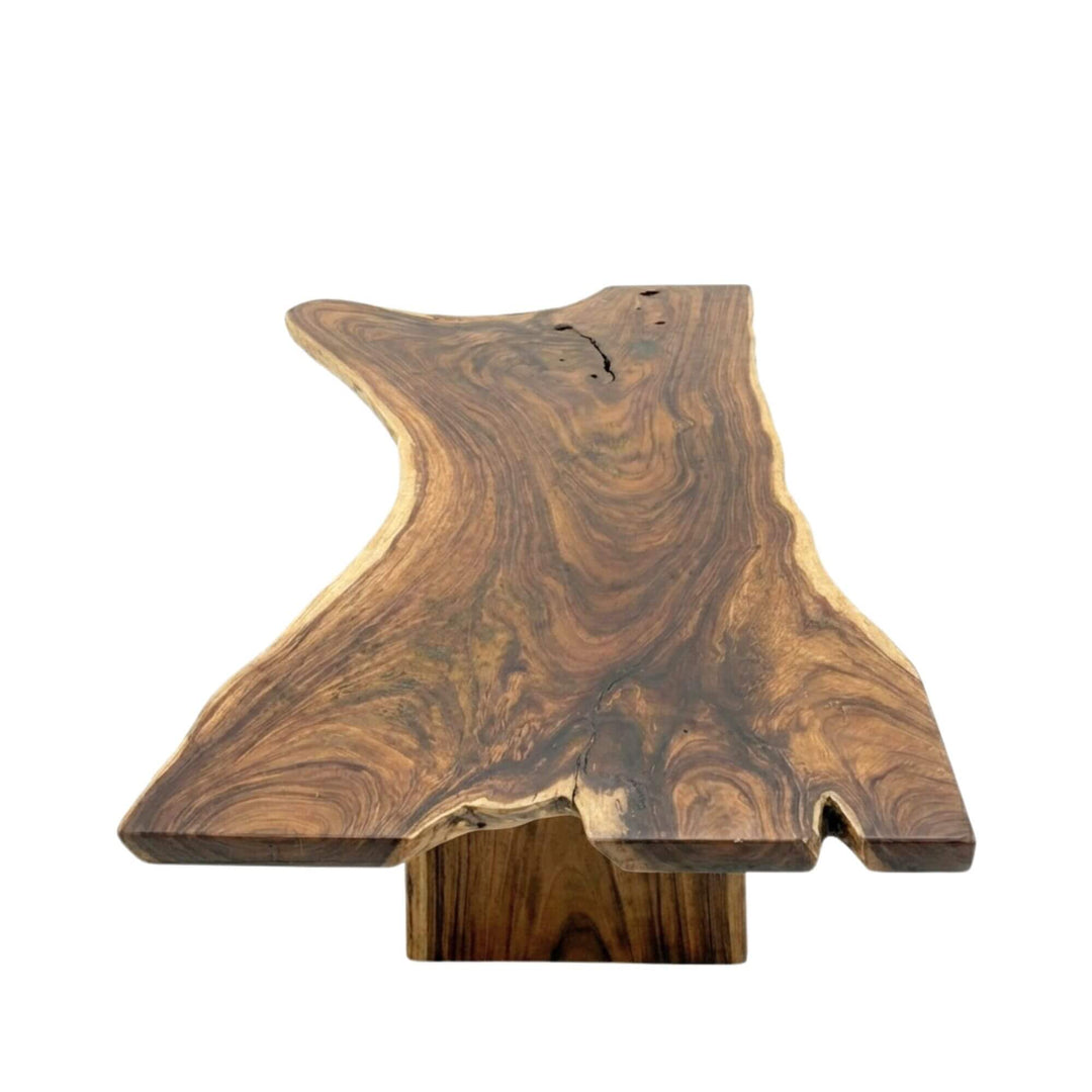 Front view of the Motu Nui suar wood dining table showcasing its expansive live-edge top and natural grain.