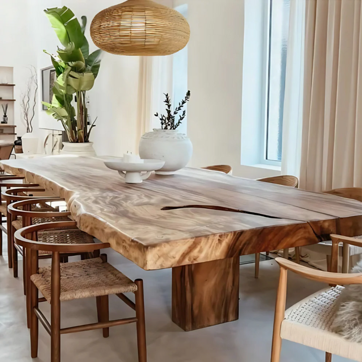 Dining area with a wooden table and chairs in a bright room.