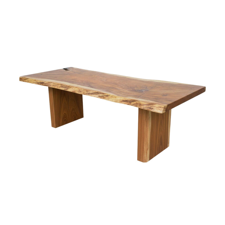 Motu Nui suar wood dining table with a natural finish on a white background