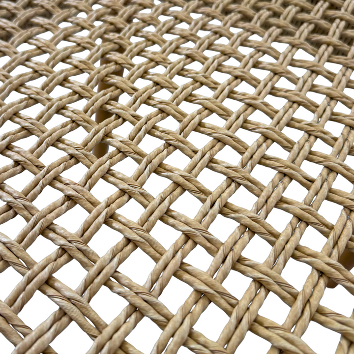 Close-up of smooth natural teak finish on Mur Dining Chair.