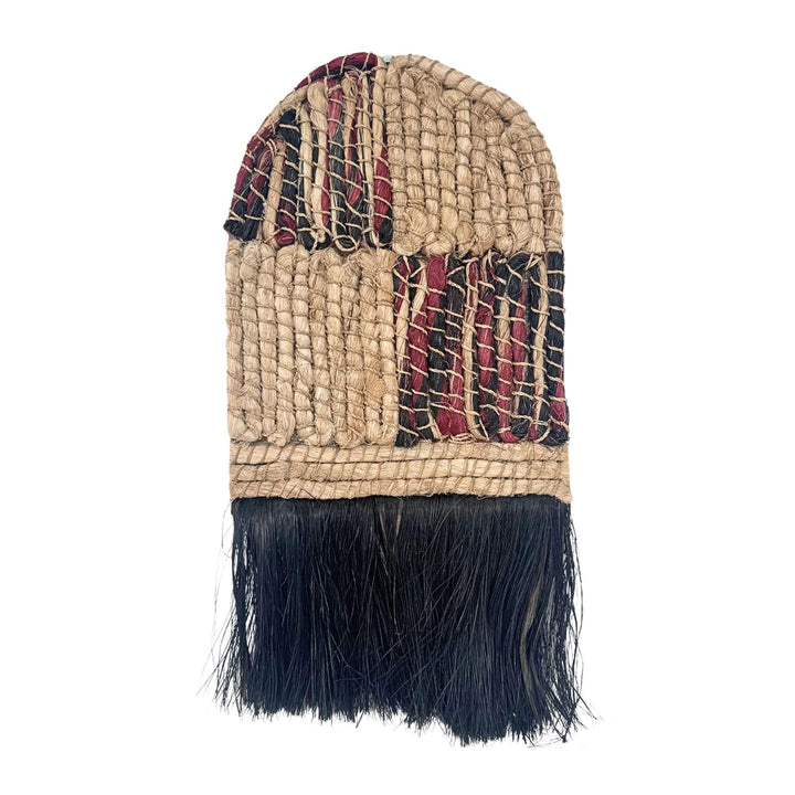 Merak Wall Deco handwoven from abaca, rattan, and cotton with natural and black patchwork design and fringe