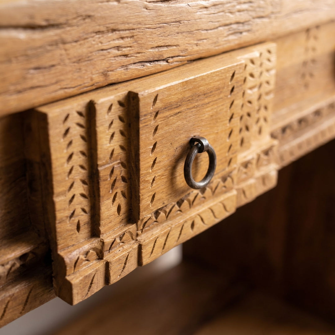 Close-up of the carved drawer panel and metal ring handle detail.