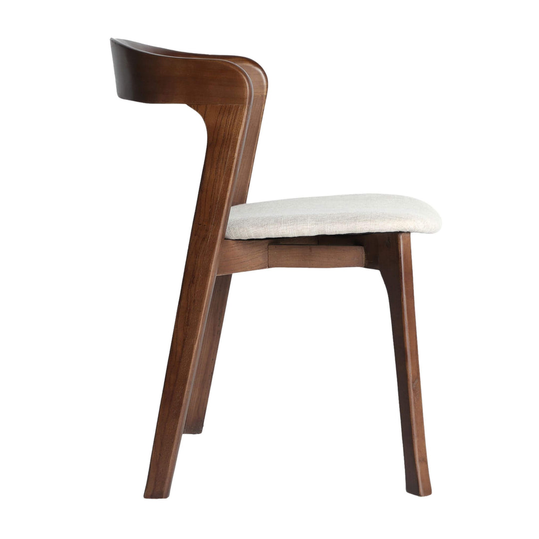 Side view highlighting sculpted elm frame and wraparound back.