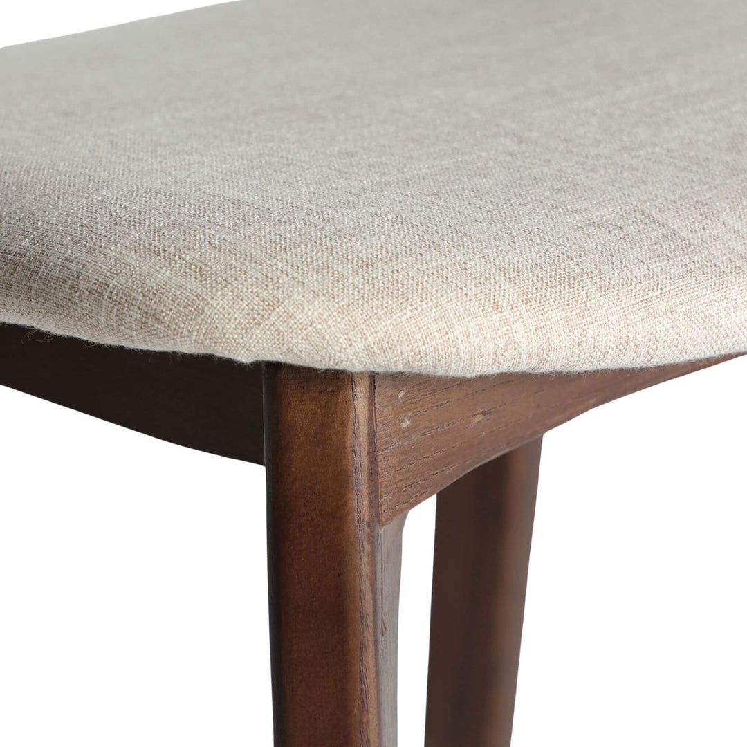 Detail of beige linen seat and elm corner joinery.