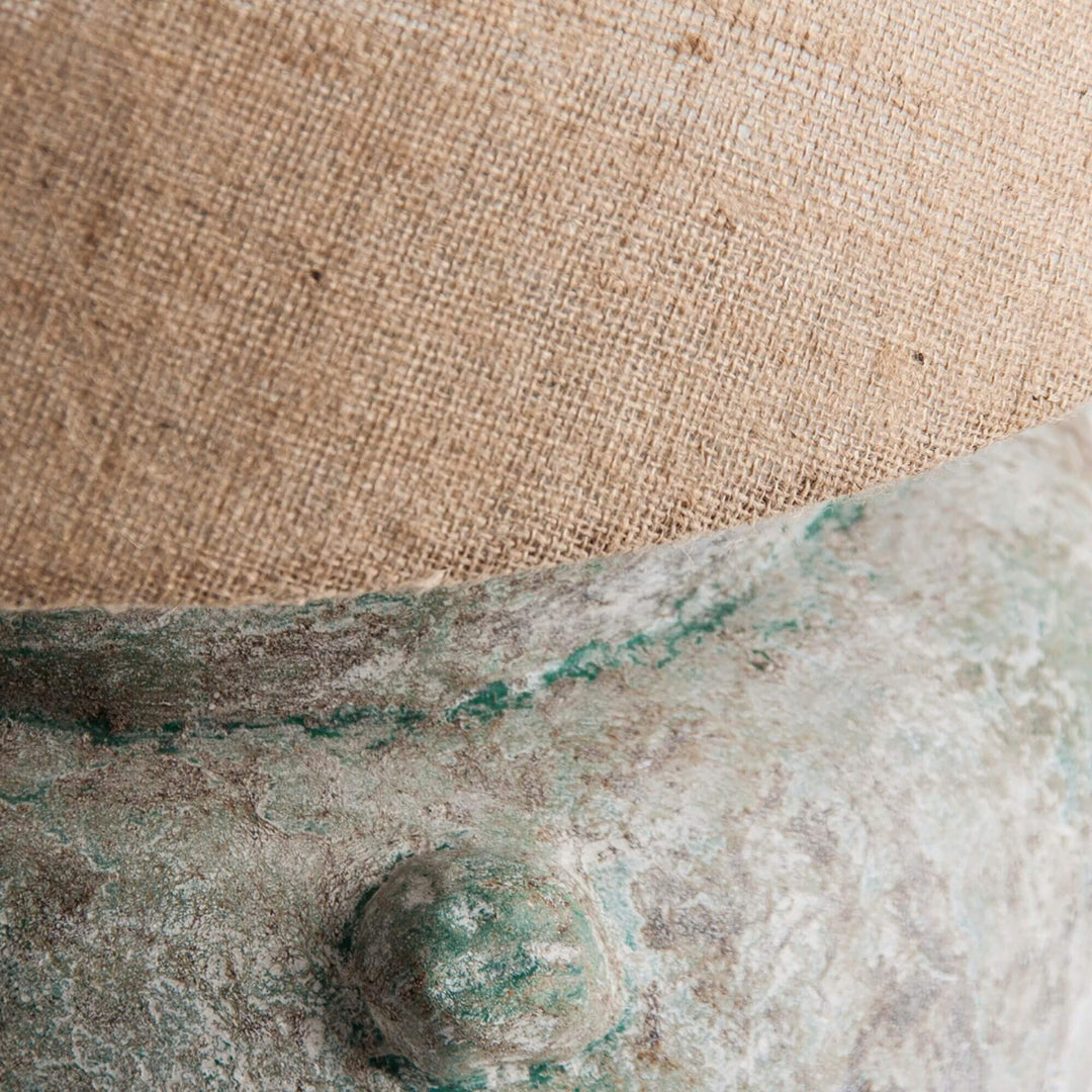 Close-up of Narvi Lamp showing textured terracotta surface and woven jute lampshade.