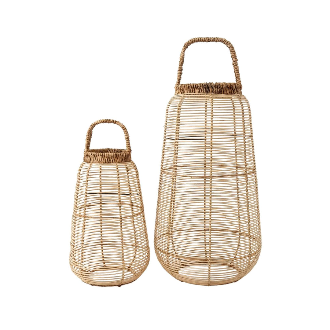 Front view of Navagio rattan lanterns in two sizes showcasing their tall woven structure and natural fiber finish.