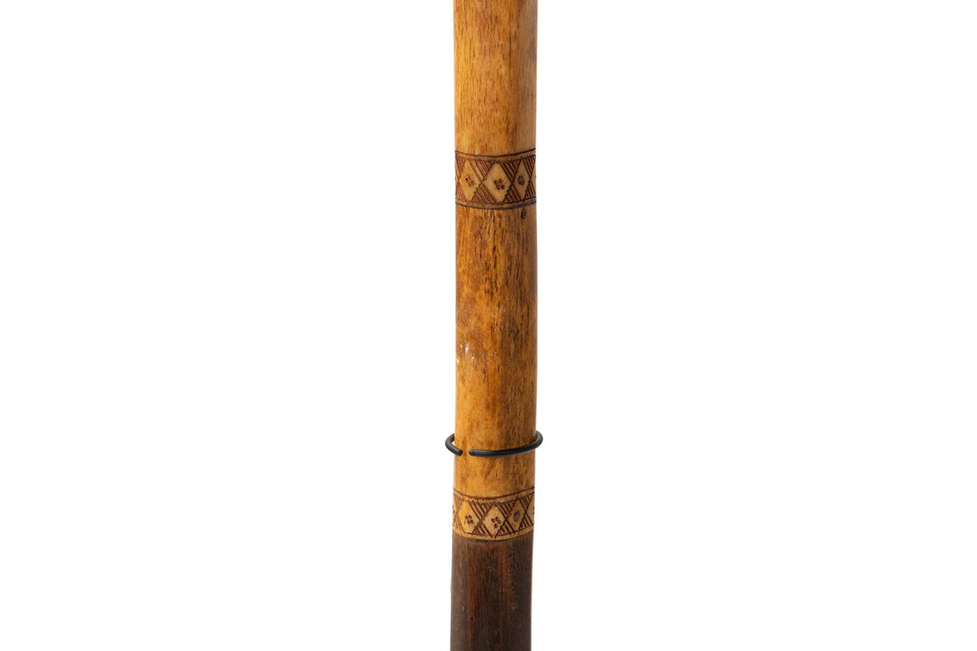 Detail view of the wooden shaft showing natural grain and engraved accents.